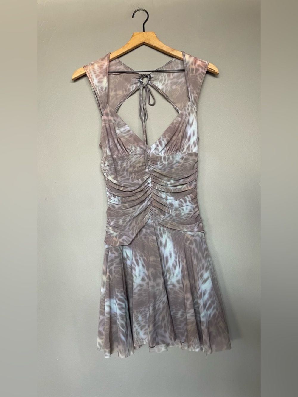 Silence + Noise ruched mini dress with a leopard print and a halter neckline.